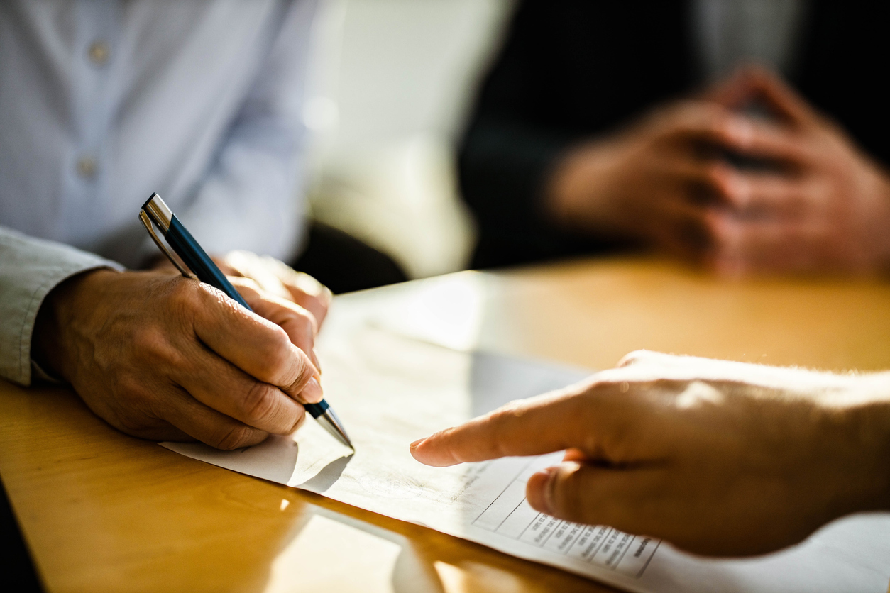 person-signing-contract contract-with-stamp-approval